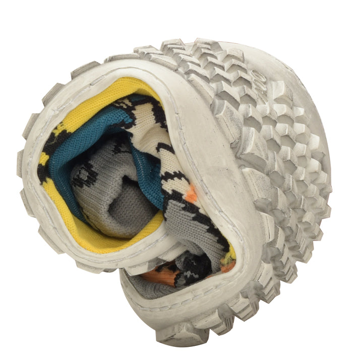 A pair of white sneakers stands upright with the soles together, displaying a textured design. Inside are SOQQ Giraffe Yellow socks from ZAQQ packed, whose vibrant patterns create a playful contrast to the monochrome shoes when viewed from above.