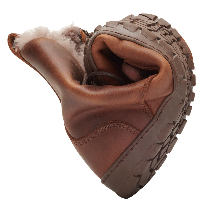 The QUINTIC Winter Antique Brown boots from ZAQQ is uniquely twisted to show off its flexibility and features a sturdy sole and a warm, sheepskin-like lining visible at the top.