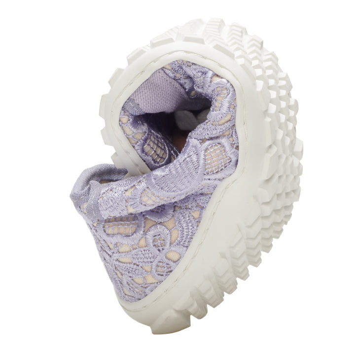 The QELLY Purple Sneaker from ZAQQ has a spiral design with a beautifully textured sole. Its upper features light purple laces decorated with cream accents and intricate floral embroidery, offering a unique aesthetic. The chunky white sole increases the flexibility of the shoe.