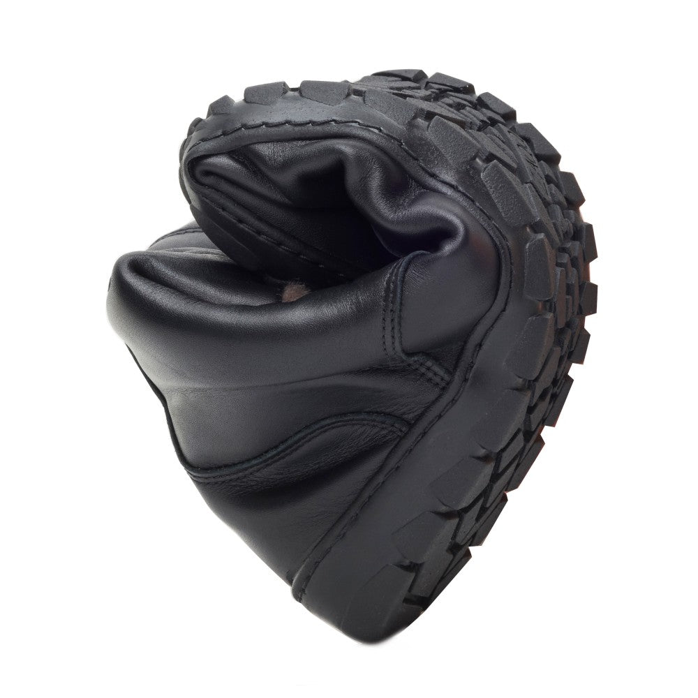 The QUINTIC Winter Waterproof Black from ZAQQ, Made from black nappa leather that looks smooth and slightly reflective, is a barefoot shoe that is so flexible that it can be folded in half. It features a lugged rubber sole with inward-turned heels that feature textured grip patterns, emphasizing both durability and pliability.