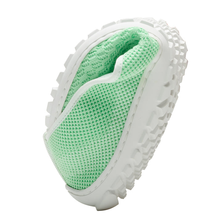 The ZAQQ SUQAR Lightgreen sneakers made of breathable cotton knit fabric are available in mint green and white. Its textured knit design and chunky, patterned sole stand out elegantly in an upright position against a simple white background.