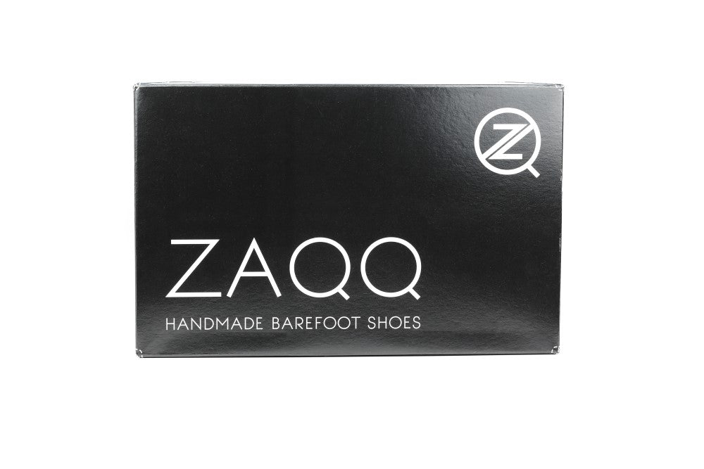 A black shoe box with ZAQQ in large white letters and “Handmade Barefoot Shoes” underneath, with a circular logo with a stylized Z in the top right corner. Perfect for QUIQ Trail Black Vegan shoes lovers, it is made from breathable mesh fabric for ultimate comfort.