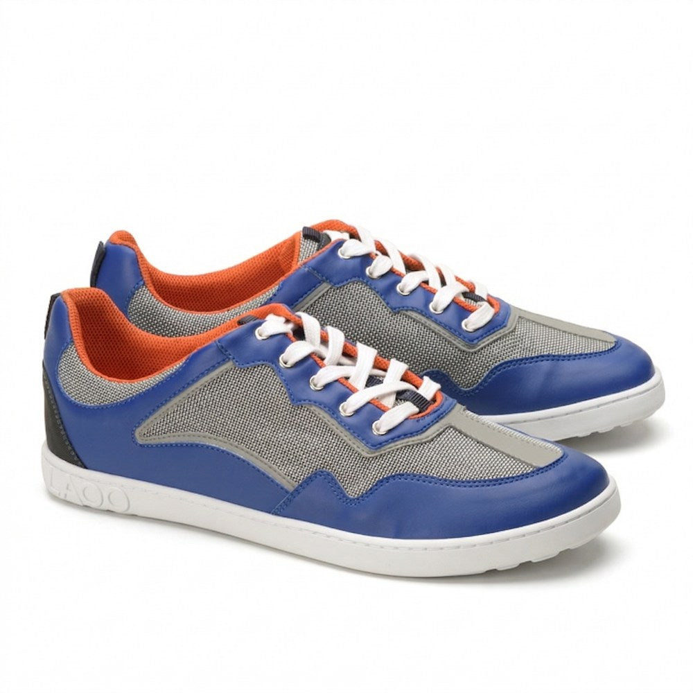 Introducing the QOPA Blue from ZAQQ: Sporty sneakers in a vibrant mix of blue, gray and orange. These shoes are made from breathable mesh fabric for excellent breathability and feature a wide toe for optimal comfort. Featuring white laces and a textured white sole, they seamlessly combine style and function.