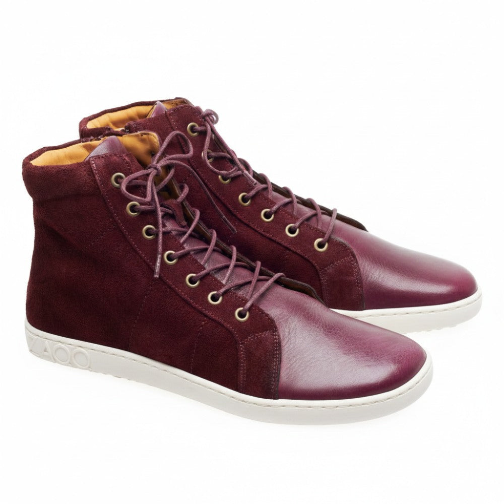 Introducing the QORE High Mazarine high-top sneakers from ZAQQ, Made from elegant burgundy suede and smooth leather with a light brown interior. These mid-cut sneakers have brown laces and a gray rubber sole with the letters AOO proudly embossed on the heel.