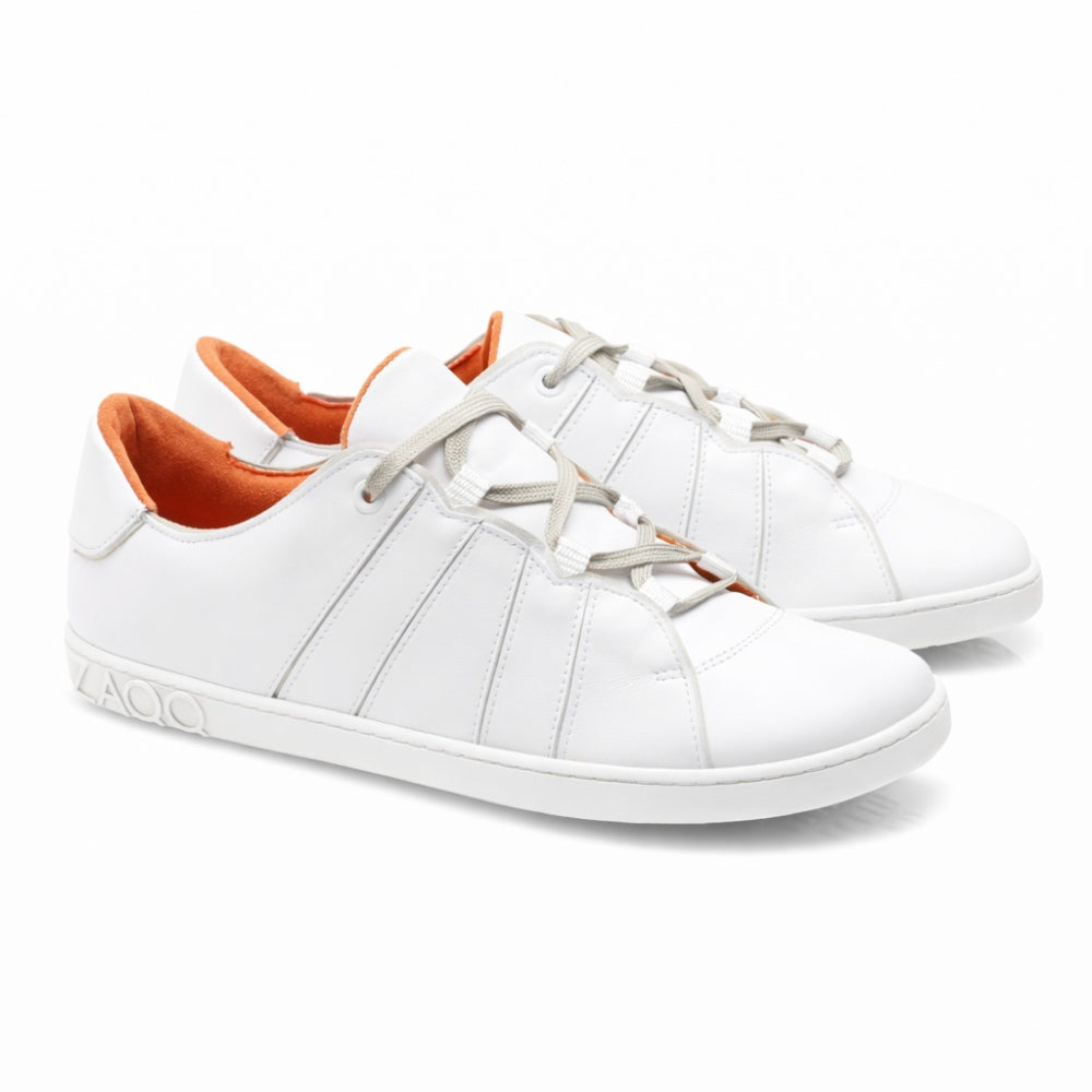 Introducing the QQQ Low White from ZAQQ, a pair of white sneakers carefully crafted from high quality nappa leather. They feature gray laces and an orange lining. The sneakers are characterized by an elegant design with subtle seams and have that ZAQQ-Logo embossed on the side of the sole, ensuring both style and functionality while providing a stunning side and front view.