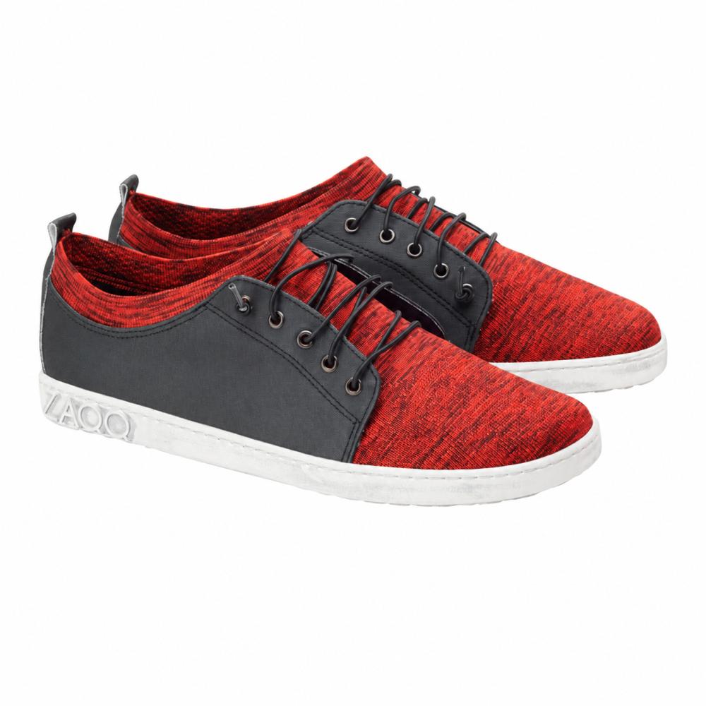 We present the QRIS Red by ZAQQ, a pair of casual red-black sneakers with striking white soles. These shoes feature vibrant red textured fabric, stylish black laces, and practical white pull tabs at the back. The distinctive word YAGO is embossed on the sides of the soles, giving them a unique touch.