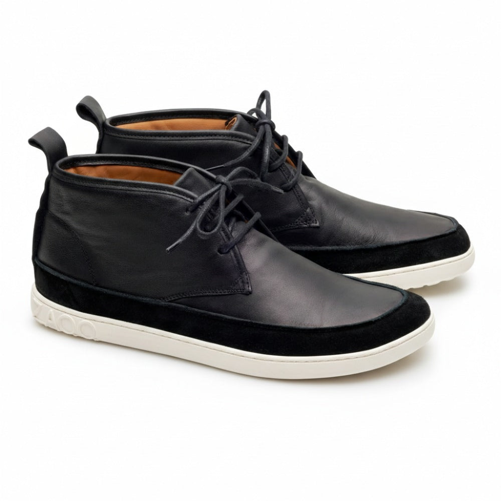 We present the QUITMAN Black from ZAQQ – these stylish black nappa leather ankle boots have white soles, black laces and a unique design pattern around the sole. Their sleek design offers a modern look, perfect for casual or semi-formal occasions.