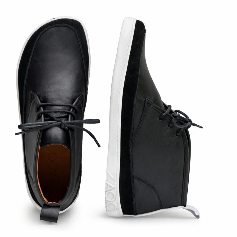 A pair of stylish black ones ZAQQ QUITMAN high-top sneakers with contrasting white soles. 