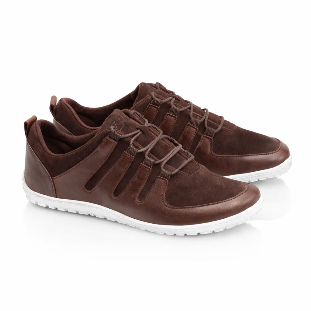 Introducing the SHOQQ Dark Brown Sneakers from ZAQQ, a chic combination of brown leather and suede, complemented by white rubber soles. These casual barefoot sneakers feature a lace-up design and are artfully showcased against a clean white background.