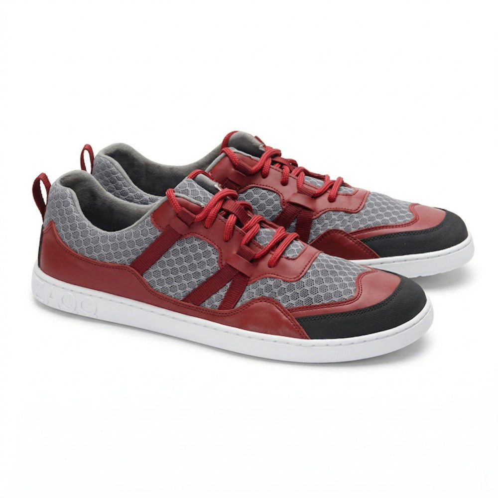The sporty sneakers ZAQQ SQATE Red features a bright red and gray honeycomb mesh fabric, complemented by red leather accents and white soles for exceptional comfort. Featuring red laces and gray lining, these shoes feature the brand name on the side of the soles.