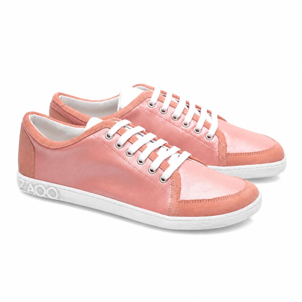 The TIQQ Rosa Sneakers by ZAQQ are crafted from high-quality pink nappa leather, complemented by white laces and soles. These shoes feature a simple, casual design, with the brand name ZAQQ elegantly placed on the back of the sole. They are presented against a bright white background.