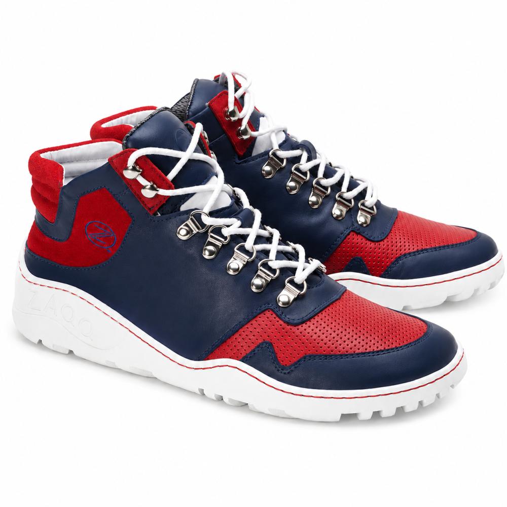 We present the waterproof VAQATION Red High-Top Sneakers from ZAQQ. These stylish shoes stand out with vibrant red, navy blue, and white colors, and are equipped with the signature ZAQQ TERRA sole. They feature white laces, metal eyelets, and perforated details on the red sections. The white outsole is designed with textured grips to enhance traction.